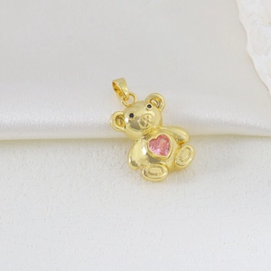 Detail of 3D teddy bear pendant in gold with a sparkling pink heart zircon inlay