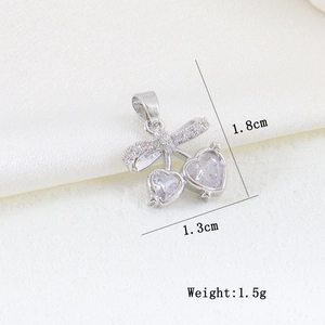 Detail of silver cherry pendant with zircon hearts and bow, size 1.8cm by 1.3cm