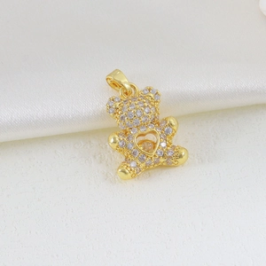Detail view of a gold-plated bear pendant with pavé cubic zirconia and heart cutout