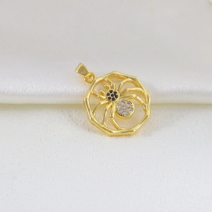 Detailed macro view of a golden spider pendant featuring black and clear zircon stones