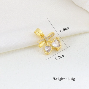 Detail of cherry-shaped gold pendant with heart zircons and dimensions of 1.8cm by 1.3cm
