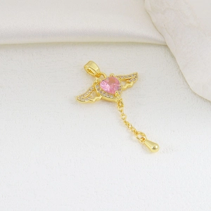 Detail view of heart-shaped pink zircon pendant with gold wings and micro-pave crystals