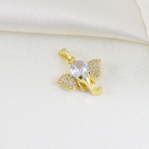 Detailed view of a gold elephant pendant with sparkling cubic zirconia on white silk