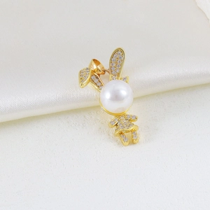Detail of golden rabbit pearl pendant with sparkling zircon micro-pave on silk background