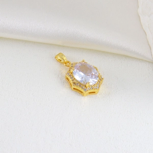 Macro detail of oval faceted zircon pendant in gold-plated frame on silk background
