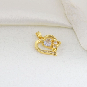 Close-up of heart-shaped gold-plated copper pendant with micro-set zircon accents
