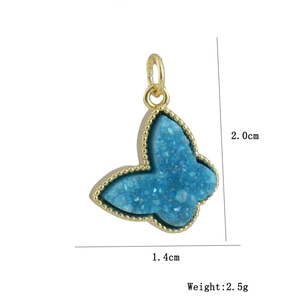 Macro shot of butterfly pendant with blue druzy stone and measurements 2.0x1.4cm