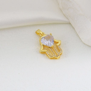 Macro shot of Hamsa hand pendant with heart-shaped zircon and micro-pave detailing