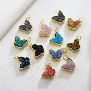 Detailed view of colorful druzy butterfly pendants with gold-plated metal edges and beads
