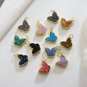 Macro shot of 12 colorful druzy crystal butterfly pendants with gold plated accents