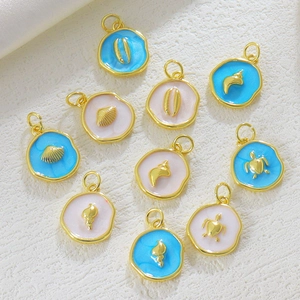 Close-up of 18K gold plated ocean pendants with turtle and shell designs for DIY jewelry