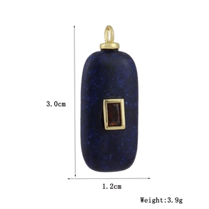 Detail view of blue stone pendant with gold metal inlay and 3.0cm x 1.2cm size label