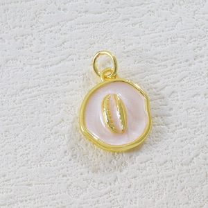 Detailed view of gold shell charm with pink enamel inlay for DIY jewelry design