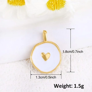 Detail of 18K gold shell heart pendant with dimensions 1.8cm x 1.3cm on white background