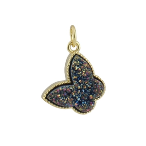 Detailed macro shot of copper zircon butterfly pendant with sparkling dark inlay and gold plating