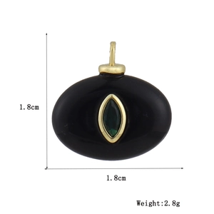 Detailed view of an oval copper pendant with black stone and green gem inlay