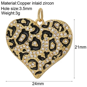 Detailed view of 18K gold heart pendant with leopard pattern and zircon inlay