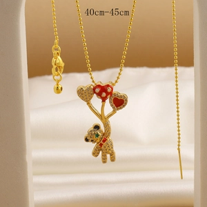 Detailed close-up of gold bear pendant with heart balloons and shiny zircons on silk
