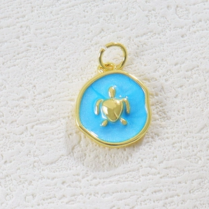 Macro view of ocean style golden sea turtle pendant with sky blue enamel finish
