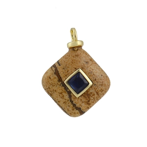 Detail of geometric stone pendant with diamond inlay and gold-plated copper edging