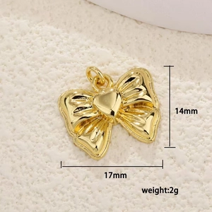 Detailed view of a gold bow pendant with heart center measuring 17mm by 14mm