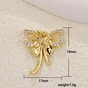 Macro shot of 17mm gold bow pendant featuring clear micro-pave cubic zirconia stones