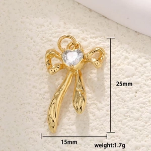 Detail view of gold butterfly pendant with clear heart zircon and size specifications