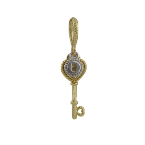 Detail view of a two-tone heart-shaped key pendant with zircon inlays and hollow bit design