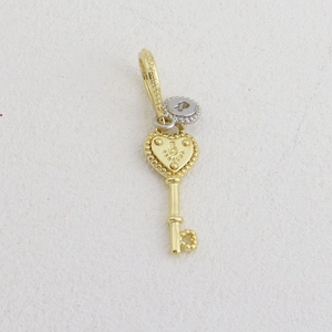 Detailed close-up of golden heart key pendant with silver lock charm for DIY jewelry