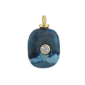 Macro detail of oval blue natural stone pendant with center diamond and gold plated edges