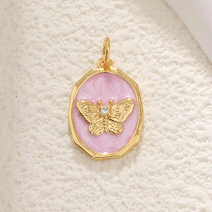Detail view of an octagonal 18K gold-plated pendant with a pink butterfly and zircon inlay