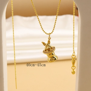 Macro detail of golden rabbit charm with star patterns and 40cm to 45cm adjustable chain