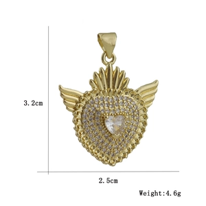 Macro view of heart-shaped wing pendant with white zircon micro-inlay and crown detail