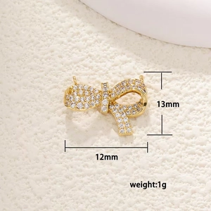 Detailed macro of gold butterfly charm with white cubic zirconia micro-pave 13mm