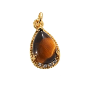 Macro detail of teardrop tiger eye pendant with gold plating and zircon embellishments