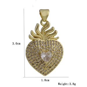 Macro detail of a gold heart pendant with micro-pave crystals and 3.0cm x 1.8cm dimensions