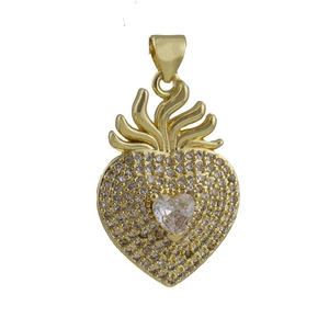 Macro detail of golden sacred heart pendant featuring paved zircons and central heart stone