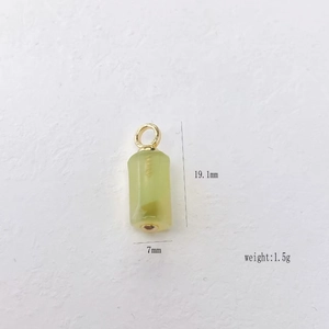 Detailed view of semi-transparent green stone pendant with size dimensions and weight labels