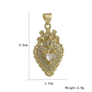 Detailed view of heart crown pendant with sparkling cubic zirconia in gold plating