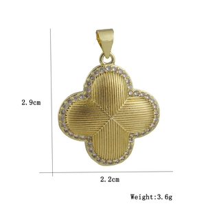 Detail of gold clover pendant with ribbed texture, cubic zirconia pavé and dimensions