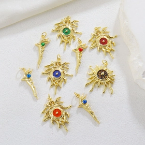 Macro shot of gold-plated Evil Eye charms in sunburst and wing shapes for DIY jewelry