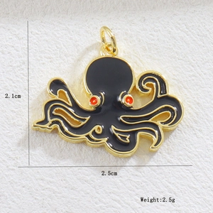 Detailed view of octopus charm with gold edges and black enamel, size 2.1x2.5cm
