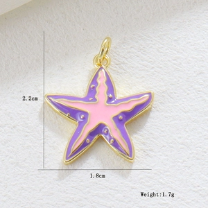 Macro detail of a starfish pendant with pink enamel and gold-plated edges, size 2.2x1.8cm