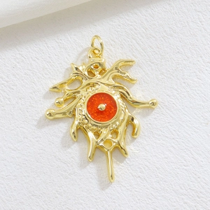 Golden Evil Eye pendant with red resin center on white textured background