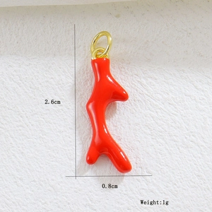 Macro shot of 2.6cm red coral charm pendant with golden ring and size measurements