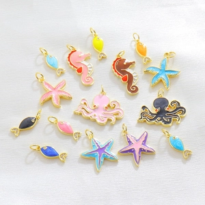 Detailed close-up of colorful sea horse and starfish charms with gold plating and crystals