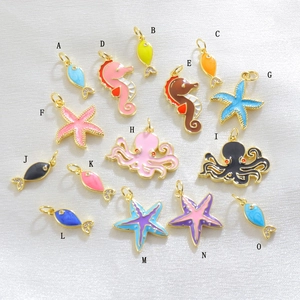 Detailed view of ocean-themed fish and seahorse enamel charms with gold plating