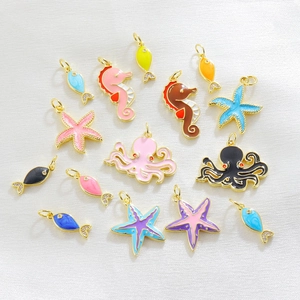 Detailed macro view of colorful enamel sea animal pendants with gold plating for jewelry DIY