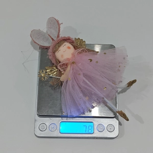 Detailed view of handmade bunny angel doll with star sequins weighing 7.8g on scale