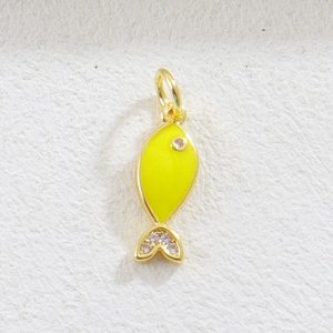 Detailed close-up of a fish-shaped charm in yellow enamel with sparkling zircon stones